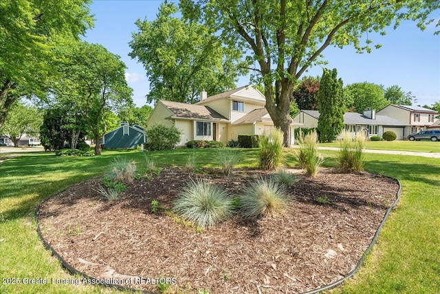4538 Cranberry Ct, Lansing, MI 48917 - view of front of property featuring a front lawn and a chimney