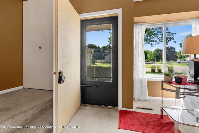 4538 Cranberry Ct, Lansing, MI 48917 - doorway to outside with carpet flooring and plenty of natural light