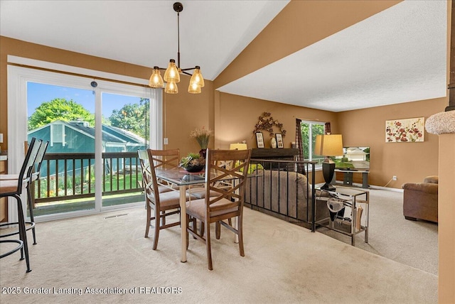 4538 Cranberry Ct, Lansing, MI 48917 - dining area featuring carpet flooring, a chandelier, and lofted ceiling