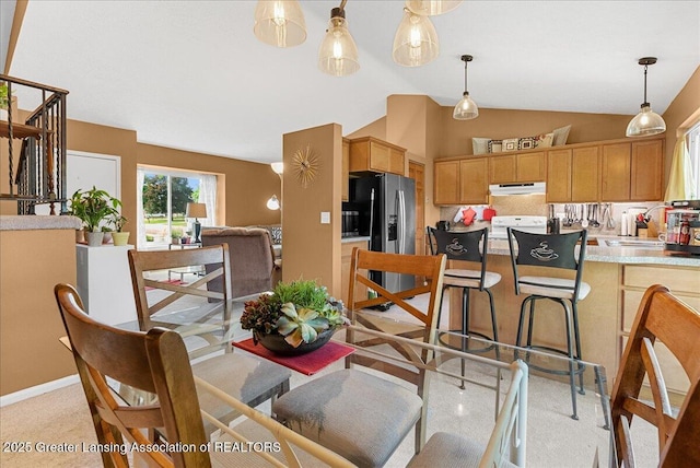 4538 Cranberry Ct, Lansing, MI 48917 - dining room with light colored carpet and vaulted ceiling