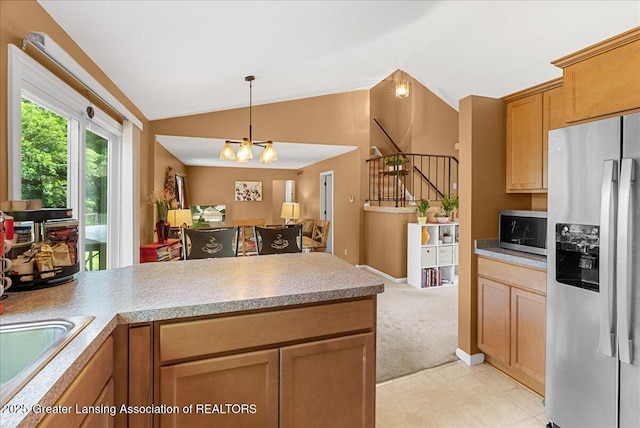 4538 Cranberry Ct, Lansing, MI 48917 - kitchen featuring stainless steel appliances, open floor plan, a peninsula, lofted ceiling, and light countertops