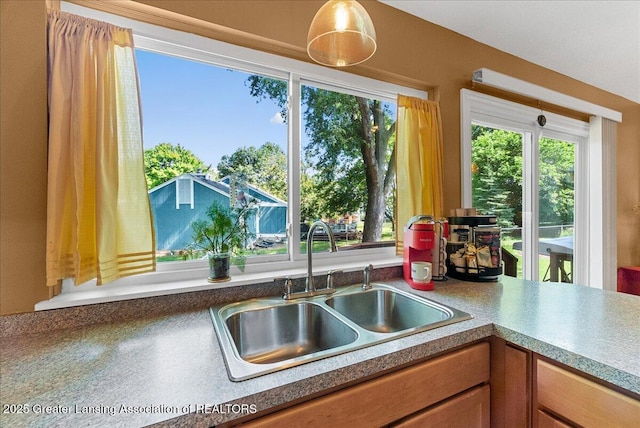 4538 Cranberry Ct, Lansing, MI 48917 - kitchen with brown cabinets and decorative light fixtures