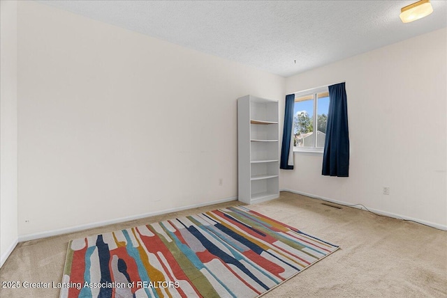 4538 Cranberry Ct, Lansing, MI 48917 - carpeted empty room featuring a textured ceiling and baseboards