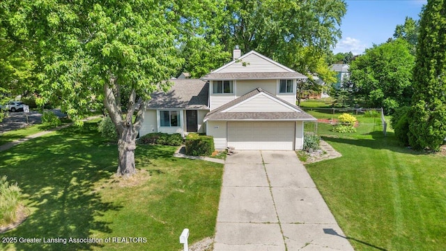 4538 Cranberry Ct, Lansing, MI 48917 - traditional home featuring concrete driveway, a chimney, a garage, and a shingled roof