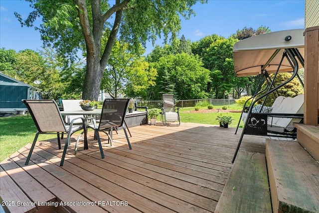 4538 Cranberry Ct, Lansing, MI 48917 - wooden terrace featuring outdoor dining area and view of wooded area
