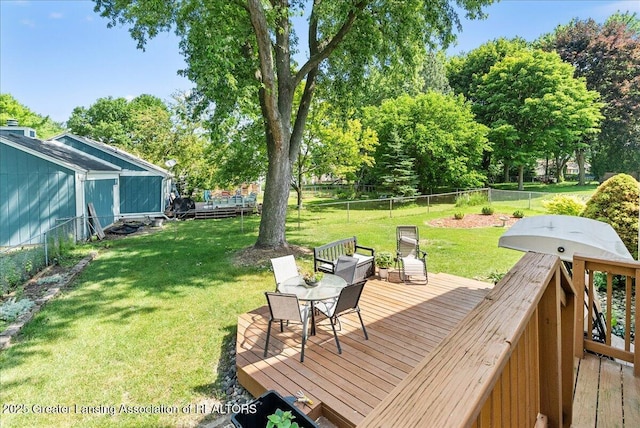 4538 Cranberry Ct, Lansing, MI 48917 - deck featuring a fenced backyard, outdoor dining space, and view of scattered trees