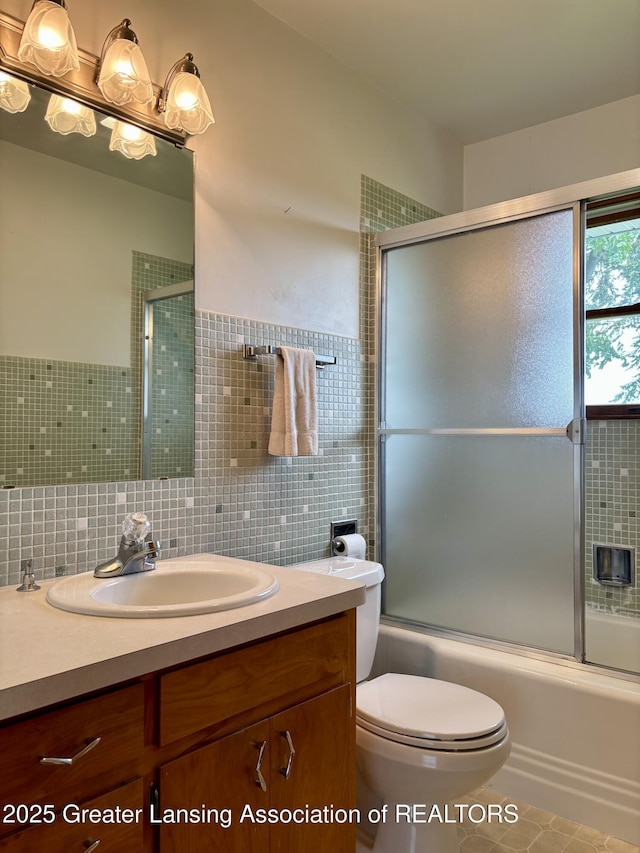 234 W Grand Ledge Hwy Unit R1, Mulliken, MI 48861 - bathroom featuring vanity, enclosed tub / shower combo, tile walls, and tile patterned floors