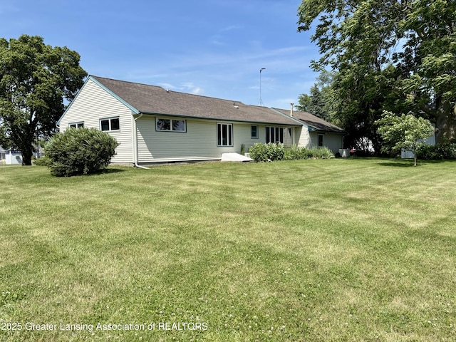 234 W Grand Ledge Hwy Unit R1, Mulliken, MI 48861 - back of property with a lawn
