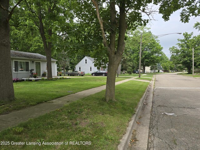 402 Crossman, Williamston, MI 48895 - view of asphalt street with curbs, sidewalks, and street lights