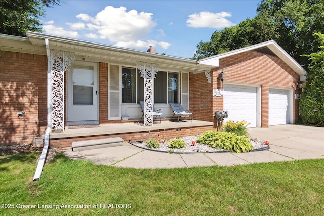 1117-1119 Blake Ave, Lansing, MI 48912 - single story home with covered porch, brick siding, concrete driveway, and a garage
