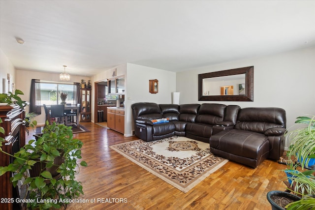 1117-1119 Blake Ave, Lansing, MI 48912 - living room with wood finished floors and a chandelier
