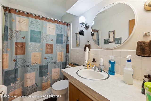 1117-1119 Blake Ave, Lansing, MI 48912 - full bathroom featuring vanity, a shower with shower curtain, tile walls, and wainscoting