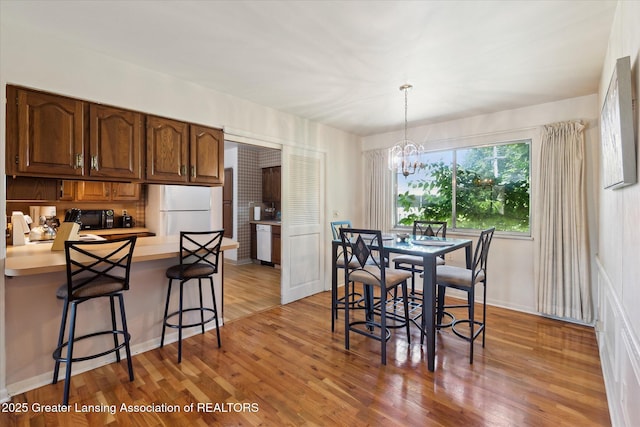 1117-1119 Blake Ave, Lansing, MI 48912 - dining room with a chandelier and light wood-type flooring