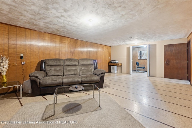 1117-1119 Blake Ave, Lansing, MI 48912 - living room featuring wooden walls and a textured ceiling