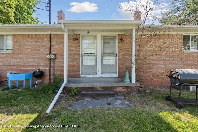 1117-1119 Blake Ave, Lansing, MI 48912 - property entrance with brick siding and a chimney