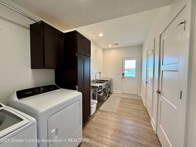 10993 Lakeside Dr, Perrinton, MI 48871 - laundry room with independent washer and dryer, cabinet space, light wood finished floors, and recessed lighting