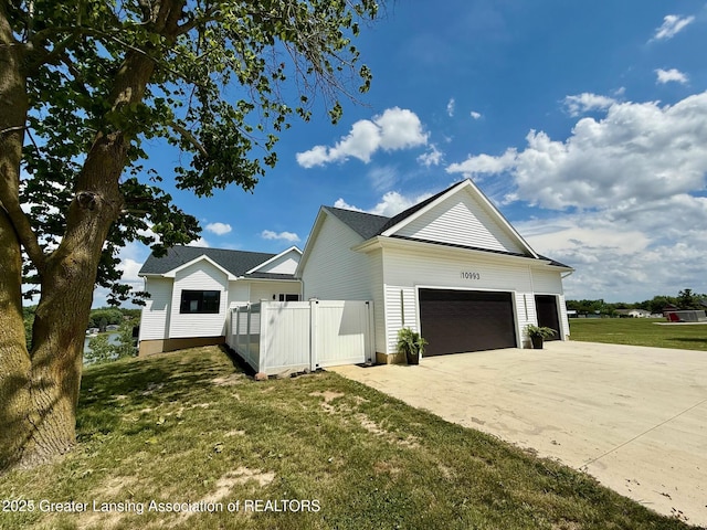 10993 Lakeside Dr, Perrinton, MI 48871 - view of property exterior with an attached garage and concrete driveway