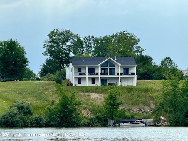 10993 Lakeside Dr, Perrinton, MI 48871 - view of front facade featuring a balcony and a water view
