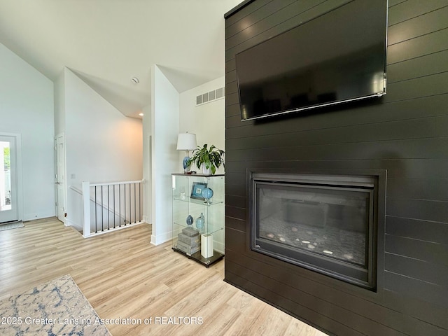 10993 Lakeside Dr, Perrinton, MI 48871 - living area featuring wood finished floors, lofted ceiling, and a large fireplace