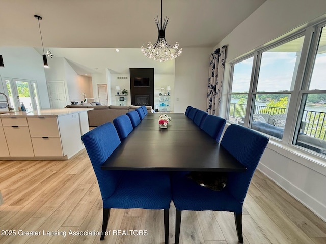 10993 Lakeside Dr, Perrinton, MI 48871 - dining room featuring light wood-style floors and a chandelier
