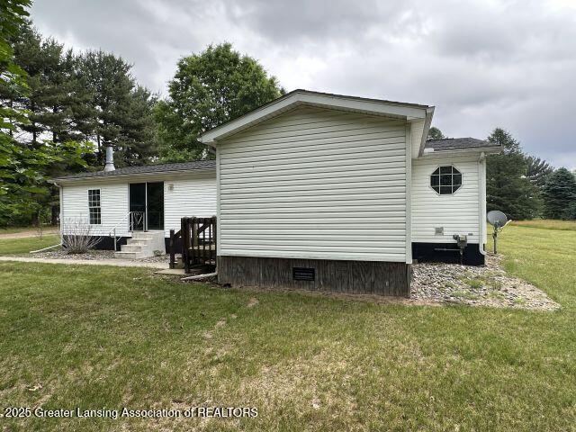 8241 Barson Rd, Rives Junction, MI 49277 - back of house featuring a lawn, entry steps, and crawl space
