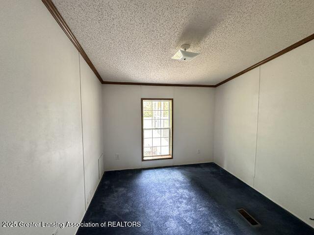 8241 Barson Rd, Rives Junction, MI 49277 - empty room with ornamental molding, a textured ceiling, and carpet