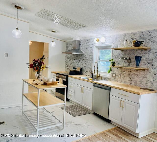 4340 Balmoral Dr, Lansing, MI 48911 - kitchen featuring appliances with stainless steel finishes, wall chimney range hood, open shelves, white cabinets, and a textured ceiling