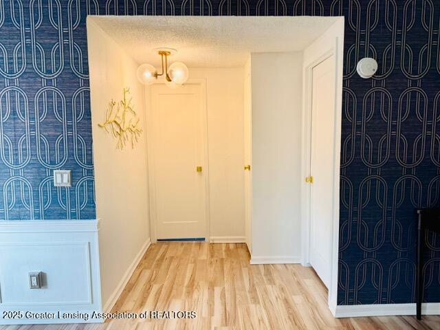 4340 Balmoral Dr, Lansing, MI 48911 - entrance foyer with wood finished floors and a chandelier