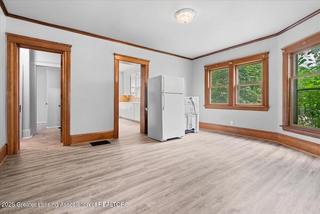 916 Wildwood Ave, Jackson, MI 49202 - empty room featuring light wood-type flooring and ornamental molding