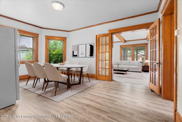 916 Wildwood Ave, Jackson, MI 49202 - dining space featuring french doors, plenty of natural light, wood finished floors, and ornamental molding