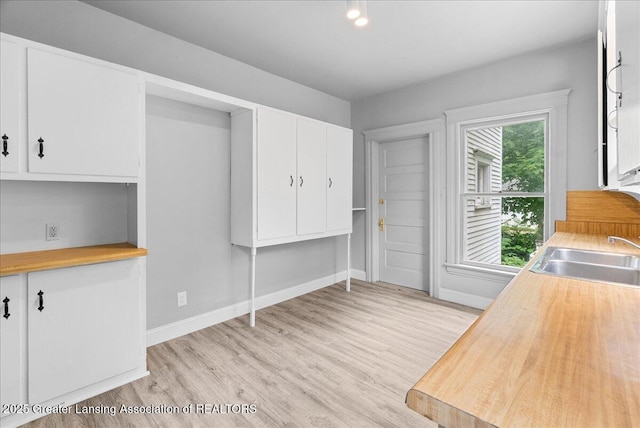 916 Wildwood Ave, Jackson, MI 49202 - kitchen with light wood-style floors, white cabinets, and butcher block countertops