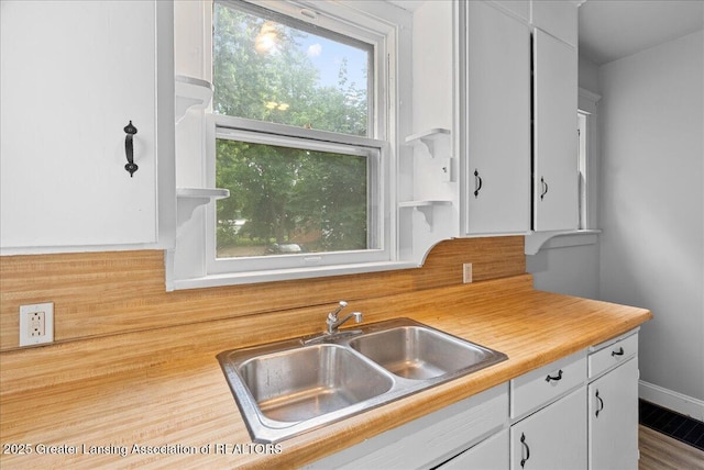 916 Wildwood Ave, Jackson, MI 49202 - kitchen with light countertops, white cabinets, and open shelves