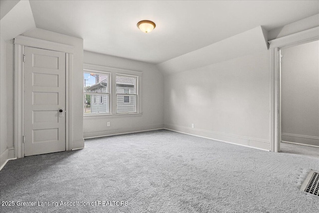 916 Wildwood Ave, Jackson, MI 49202 - unfurnished bedroom with vaulted ceiling and carpet floors
