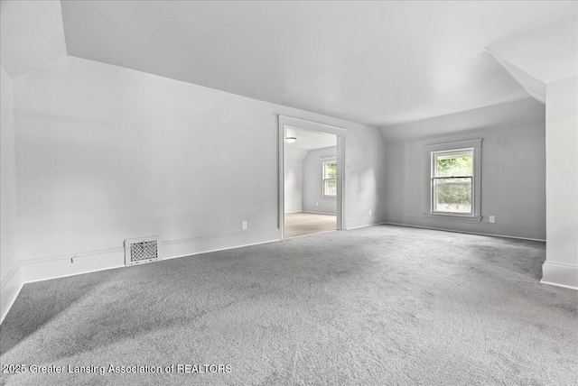 916 Wildwood Ave, Jackson, MI 49202 - unfurnished room with vaulted ceiling and carpet flooring