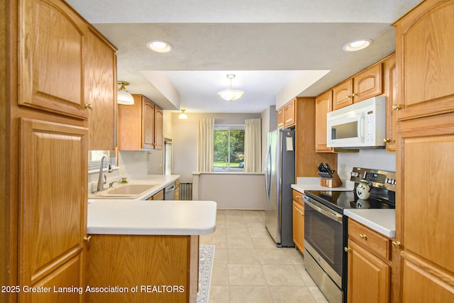 1809 S Holly Way, Lansing, MI 48910 - kitchen with stainless steel appliances, light countertops, a peninsula, light tile patterned flooring, and recessed lighting