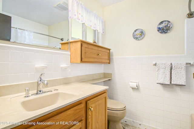 1809 S Holly Way, Lansing, MI 48910 - bathroom featuring tile walls, vanity, curtained shower, and wainscoting
