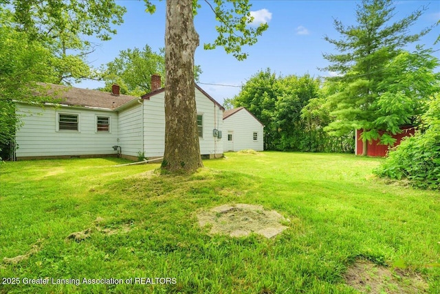 737 Jessop Ave, Lansing, MI 48910 - view of grassy yard with an outdoor structure