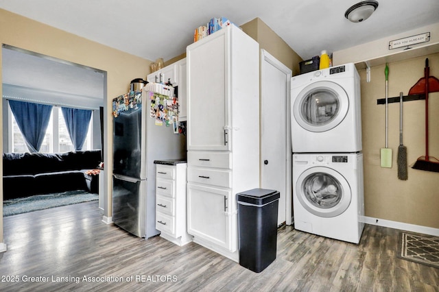 2208 Washington Rd, Lansing, MI 48911 - washroom featuring estacked washer and dryer and light wood finished floors