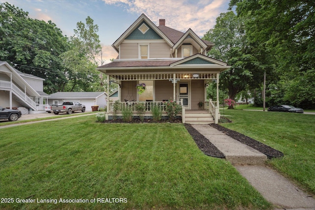 409 E Higham St, Saint Johns, MI 48879 - victorian home with a porch, a front lawn, a shingled roof, a chimney, and a garage