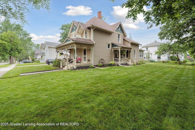409 E Higham St, Saint Johns, MI 48879 - victorian home featuring covered porch, a front yard, and a chimney