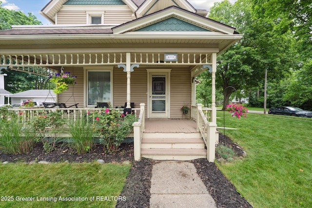 409 E Higham St, Saint Johns, MI 48879 - victorian home with covered porch, a front yard, and roof with shingles
