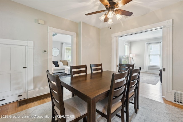 409 E Higham St, Saint Johns, MI 48879 - dining room with light wood-style flooring, a ceiling fan, and plenty of natural light