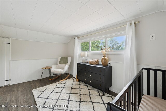 409 E Higham St, Saint Johns, MI 48879 - living area with wood finished floors, vaulted ceiling, and a wainscoted wall