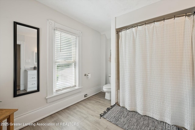 409 E Higham St, Saint Johns, MI 48879 - full bathroom featuring wood finished floors, vanity, and curtained shower