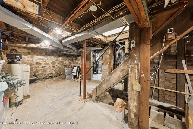 409 E Higham St, Saint Johns, MI 48879 - unfinished below grade area with a water softener system and water heater