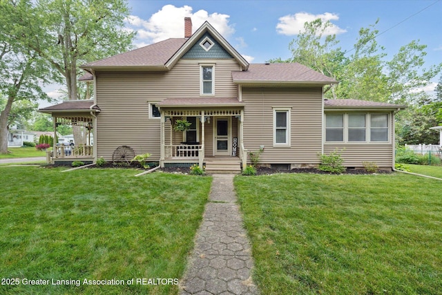 409 E Higham St, Saint Johns, MI 48879 - victorian-style house featuring a porch, a front lawn, a chimney, and a shingled roof