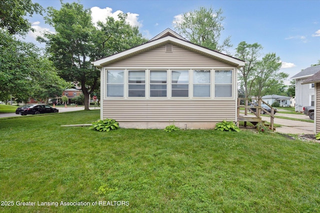 409 E Higham St, Saint Johns, MI 48879 - view of side of home with a yard