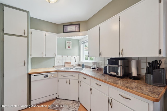 536 Hunter Blvd, Lansing, MI 48910 - kitchen with dishwasher, white cabinets, decorative backsplash, and light wood-style floors