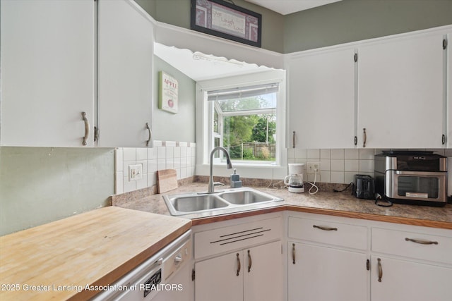 536 Hunter Blvd, Lansing, MI 48910 - kitchen with white cabinets, decorative backsplash, and light countertops