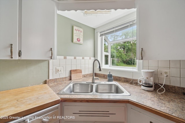 536 Hunter Blvd, Lansing, MI 48910 - kitchen featuring white cabinets, decorative backsplash, and light countertops